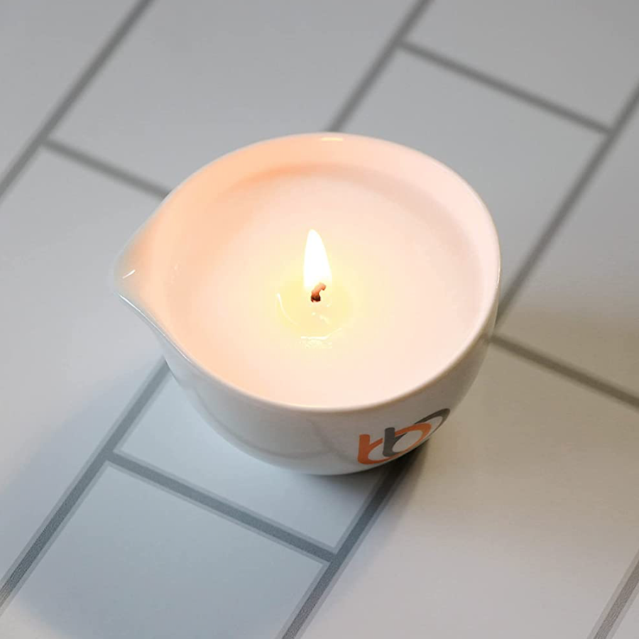 Burn & Bliss Soy Wax Massage Oil Candle - Soothing Lotus on tiles